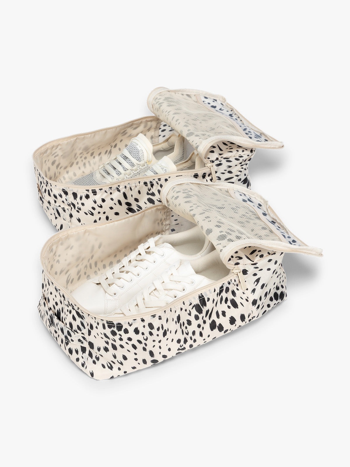 Opened view with shoes inside the White and black animal print Snow Leopard rectangular CALPAK shoe cube with zippers and top handle shown on a plain background; KSB2001-SNOW-LEOPARD