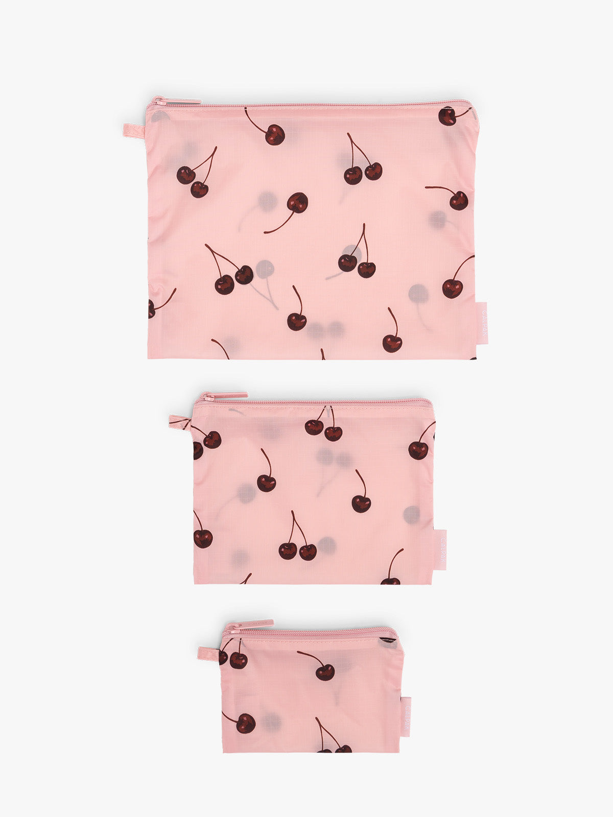 CALPAK  Compakt Zippered Pouch in pink with cherry pattern laid out; KZB2001-BLOSSOM-CHERRY