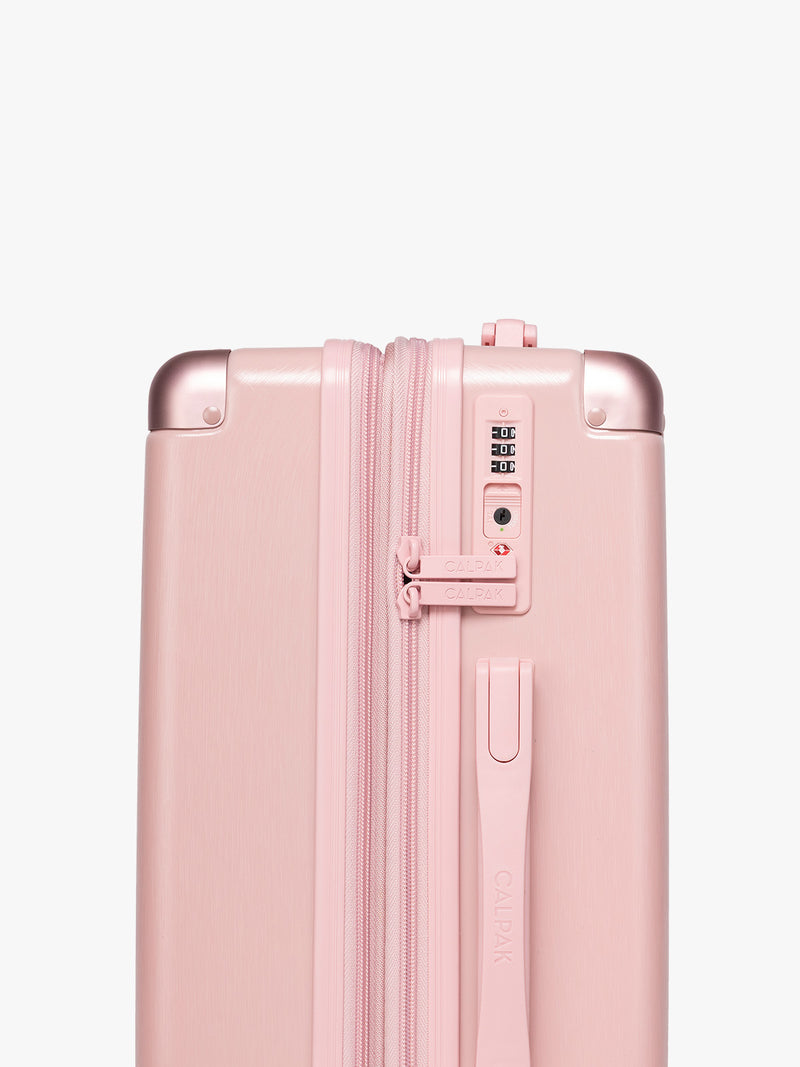 TSA-approved lock on the CALPAK Ambeur Carry-On Luggage in metallic pink Blossom with pink wheels