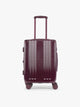 CALPAK Dark Cherry burgundy Ambeur Carry On  hard-shell suitcase with a telescoping handle extended, shown from the front against a plain white background; LAM1020-DARK-CHERRY