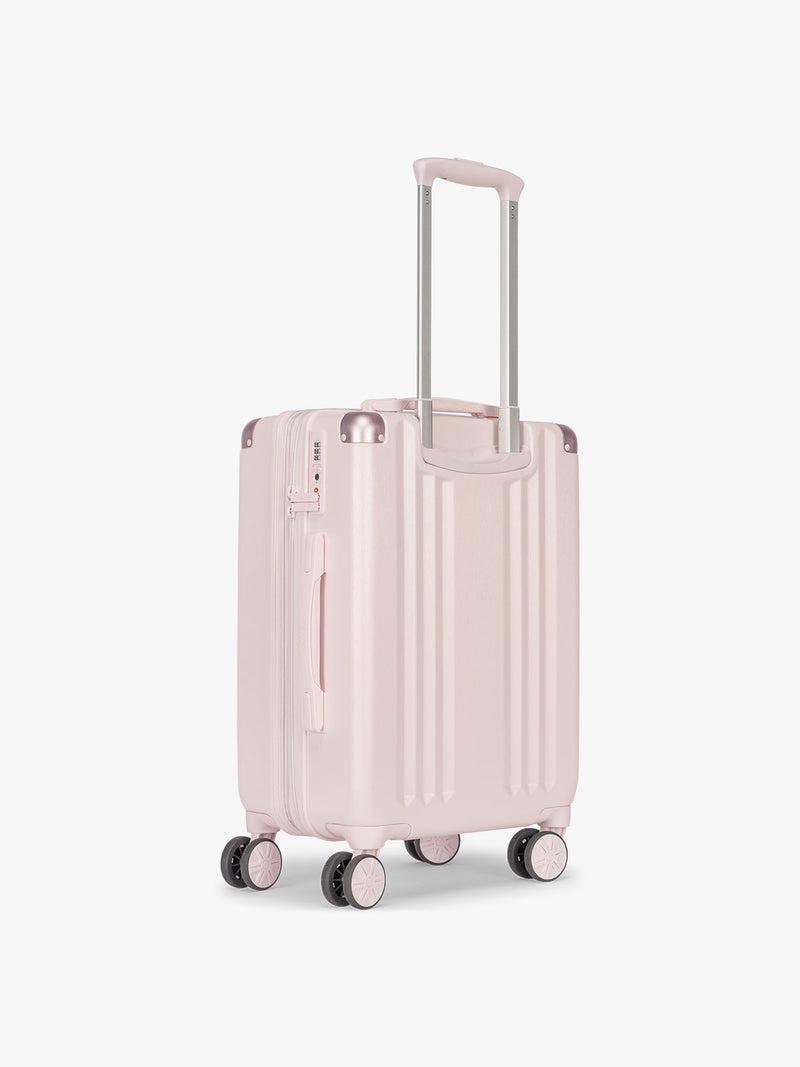 Backside of CALPAK Ambeur Carry On Luggage in light pink Shell Pink with handles and wheels