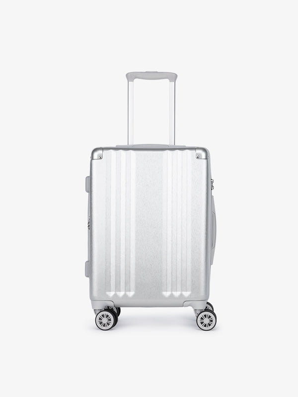 Studio product shot of front-facing lightweight silver CALPAK Ambeur 22-inch hardside rolling spinner carry-on luggage