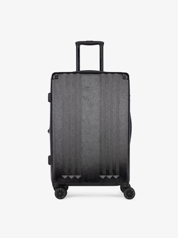 Studio product shot of front-facing CALPAK Ambeur black medium 26-inch lightweight hardshell rolling luggage