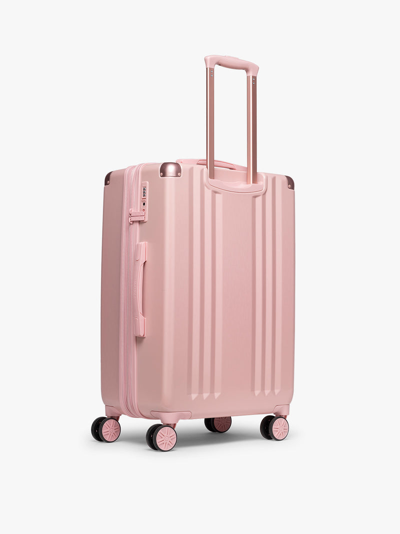 Back view of CALPAK Ambeur Medium Luggage in metallic pink Blossom with pink wheels