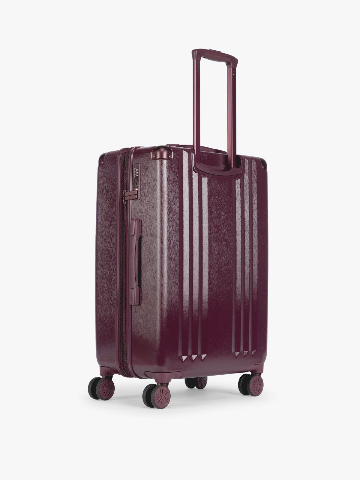 Back side of CALPAK Ambeur Medium Luggage in dark burgundy Dark Cherry with vertical ribbed detailing and an extended telescoping handle, shown from the front against a plain white background; LAM1024-DARK-CHERRY
