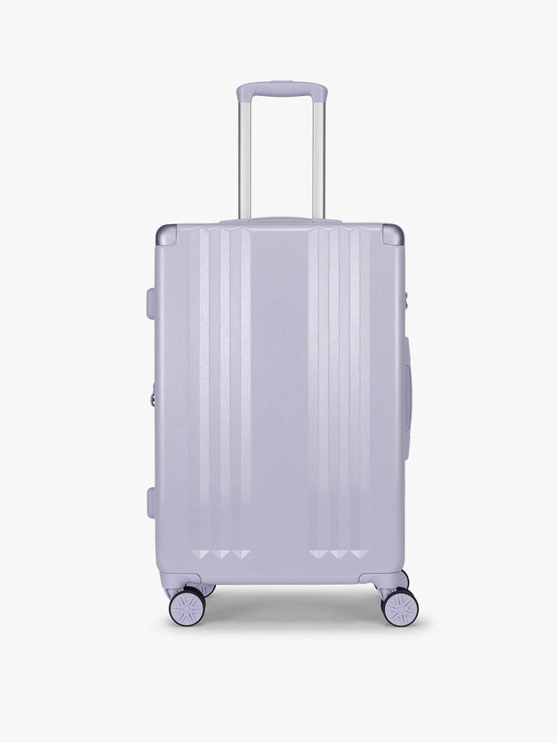 CALPAK Ambeur three piece luggage set in medium size in light purple lavender with handles and spinner wheels on a white background