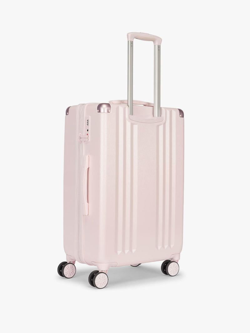 Backside of CALPAK Ambeur Medium Luggage in light pink Shell Pink with handles and wheels