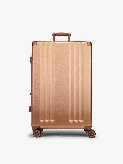 Studio product shot of front-facing CALPAK Ambeur large 30-inch hardshell luggage with 360 spinner wheels in copper; model LAM1028-COPPER