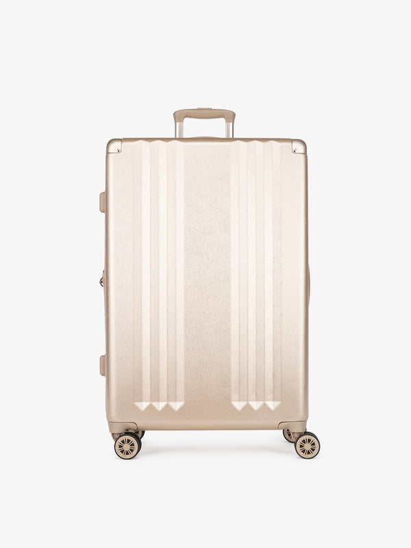 CALPAK Ambeur large 30-inch gold hardshell spinner luggage