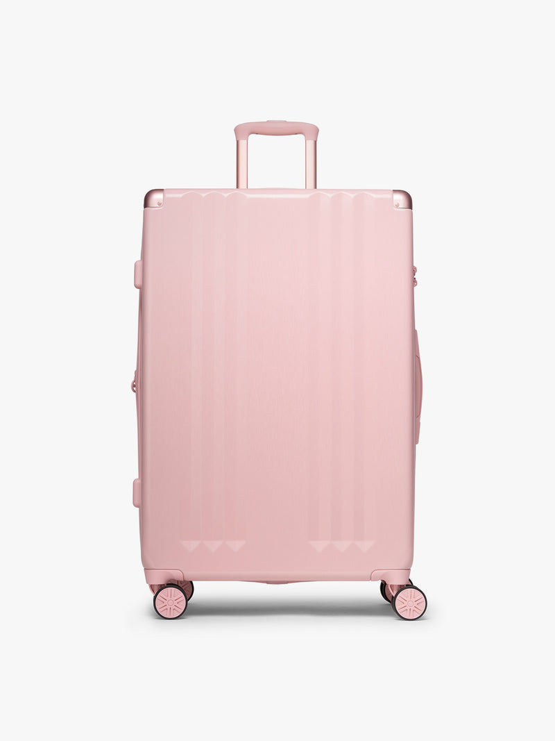 CALPAK pc Ambeur Luggage Set featuring the Ambeur Large Luggage in metallic pink Blossom with pink wheels