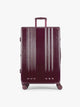CALPAK Ambeur Large Luggage in dark burgundy Dark Cherry with vertical ribbed detailing and an extended telescoping handle, shown against a plain white background; LAM1028-DARK-CHERRY