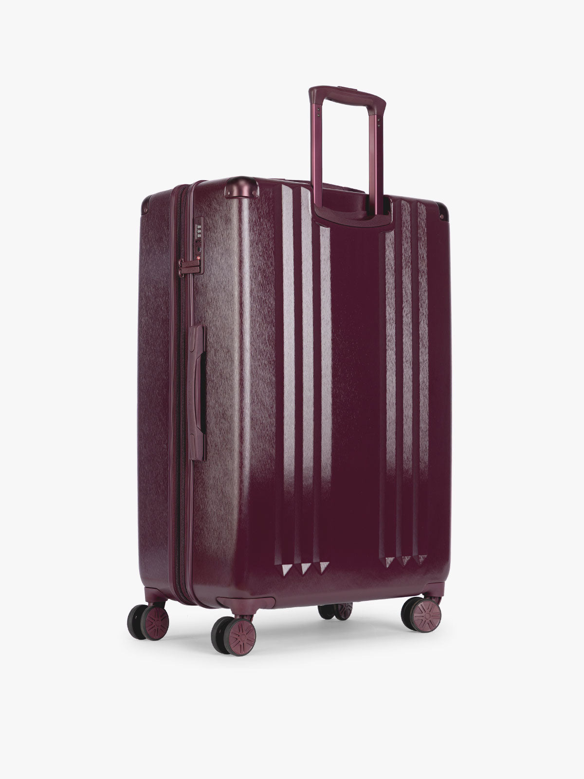 Backside of CALPAK Ambeur Large Luggage in dark burgundy Dark Cherry with vertical ribbed detailing and an extended telescoping handle, shown against a plain white background; LAM1028-DARK-CHERRY