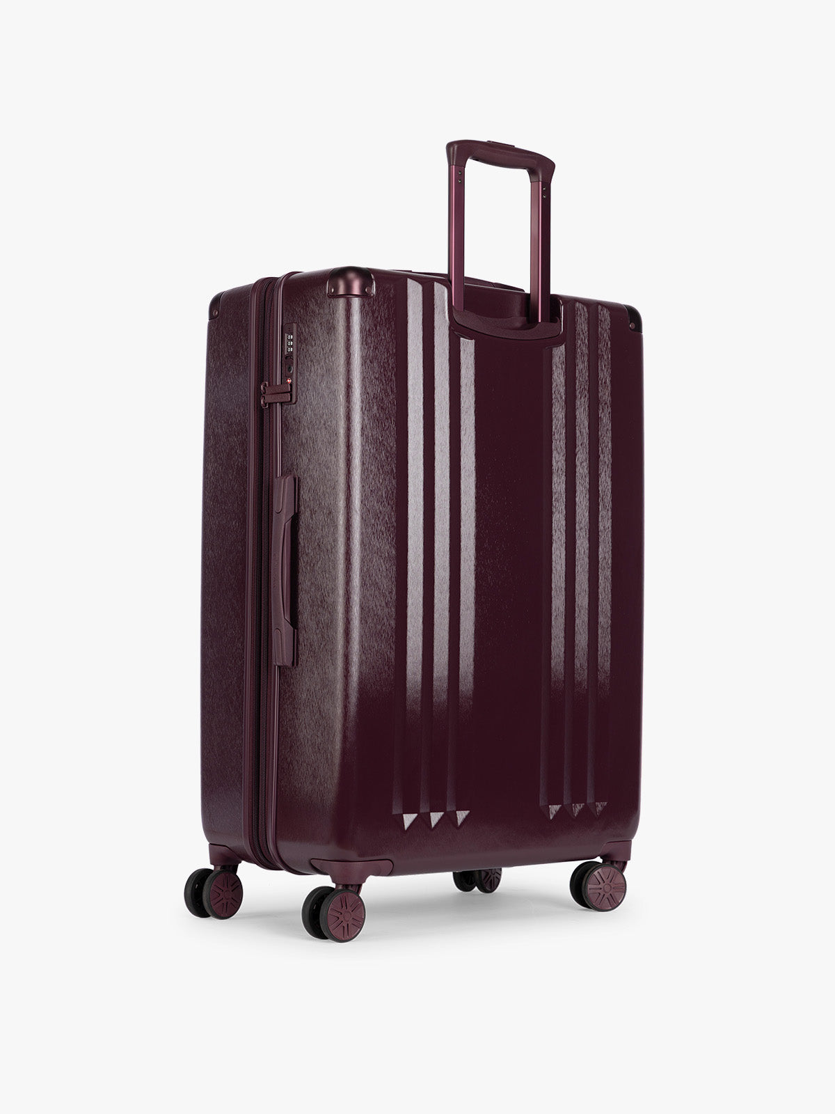 Backside of CALPAK Ambeur Large Luggage in dark burgundy Dark Cherry with vertical ribbed detailing and an extended telescoping handle, shown against a plain white background; LAM1028-DARK-CHERRY