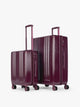 CALPAK Two-Piece Set in dark burgundy Dark Cherry which includes the Carry On and Large sizes with vertical ridges, shown on a clean white background; LAM2000-DARK-CHERRY