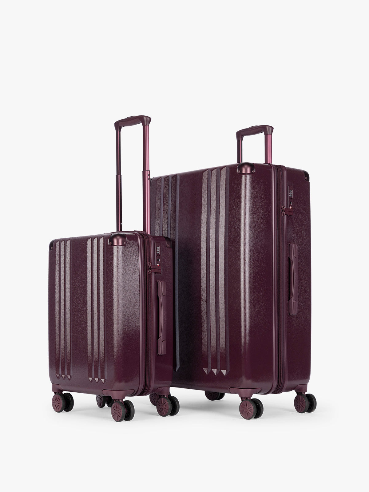 CALPAK Two-Piece Set in dark burgundy Dark Cherry which includes the Carry On and Large sizes with vertical ridges, shown on a clean white background; LAM2000-DARK-CHERRY