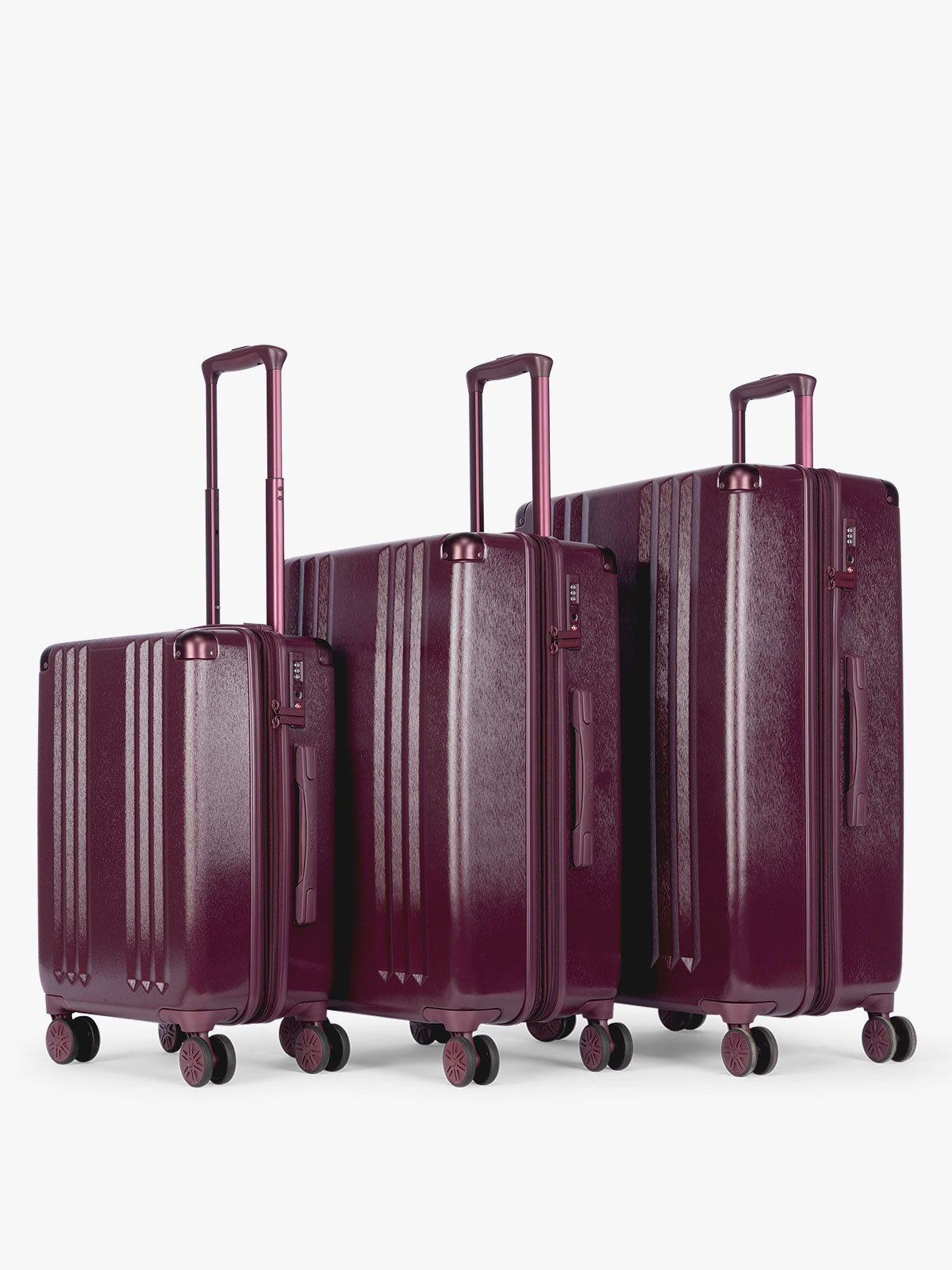 CALPAK Ambeur Three-Piece Set in dark burgundy Dark Cherry, featuring different sizes with telescoping handles extended, set against a plain light gray background; LAM3000-DARK-CHERRY