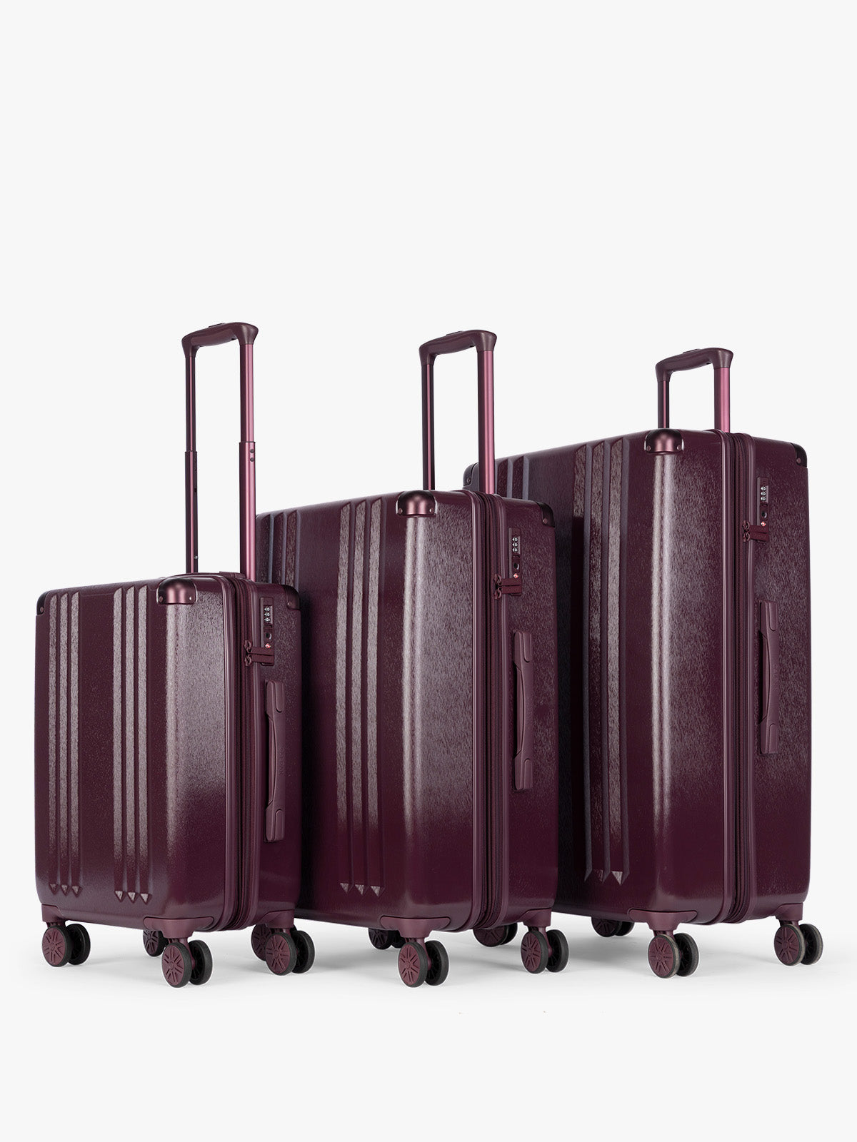 CALPAK Ambeur Three-Piece Set in dark burgundy Dark Cherry, featuring different sizes with telescoping handles extended, set against a plain light gray background; LAM3000-DARK-CHERRY