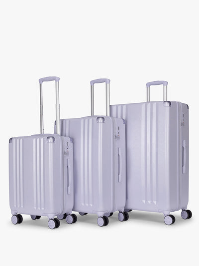 CALPAK Ambeur three piece luggage set in carry on, medium, and large sizes in light purple lavender with handles and spinner wheels on a white background; LAM3000-SEA-GLASS view 1