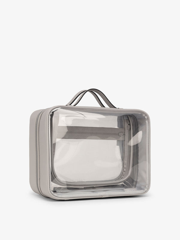 CALPAK large clear skincare bag with multiple zippered compartments in cool grey