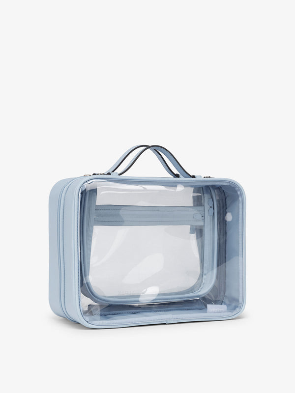 CALPAK large clear skincare bag with multiple zippered compartments in sky blue