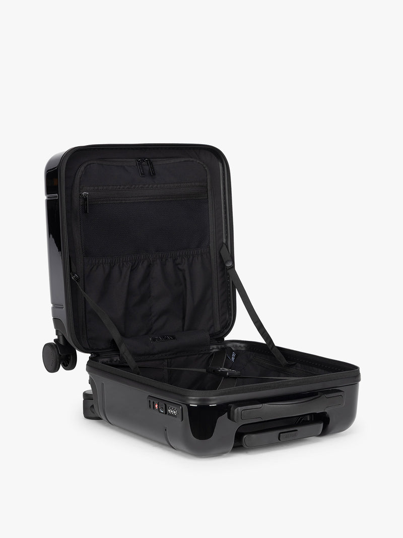 CALPAK Glazed Black Hue Mini Carry On suitcase with a black handle opened on a white background