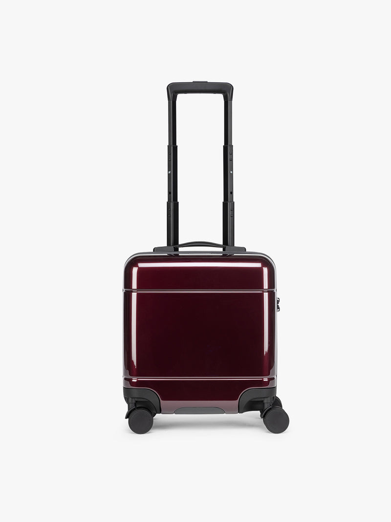 CALPAK Glazed Dark Cherry Hue Mini Carry On Red suitcase with a black handle on a white background