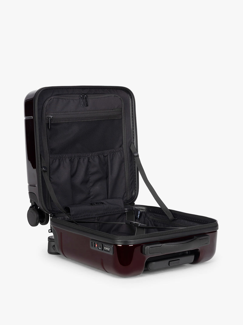 CALPAK Glazed Dark Cherry Hue Mini Carry On Red suitcase with a black handle open view on a white background