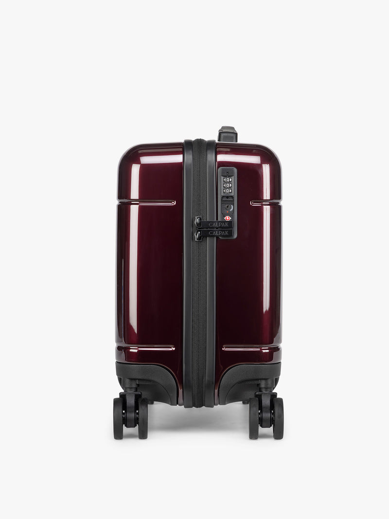 CALPAK Glazed Dark Cherry Hue Mini Carry On Red suitcase with a black handle side view on a white background