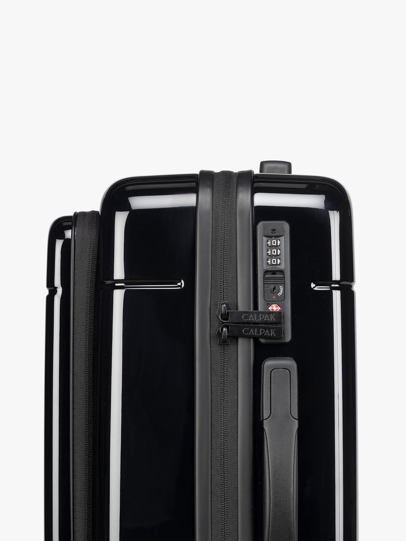 TSA approved lock on CALPAK Hue Front Pocket Carry On Luggage in maroon Glazed Black