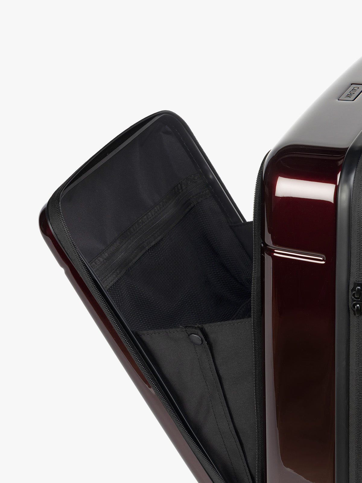 Front Pocket close up of CALPAK Hue Front Pocket Carry On Luggage in maroon Glazed Dark Cherry ; LHU1020-GLAZED-DARK-CHERRY