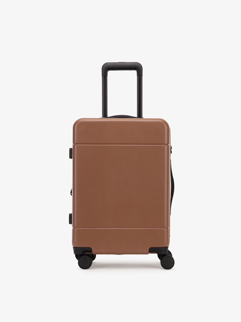 CALPAK Hue hard shell rolling carry-on luggage in pink sand color