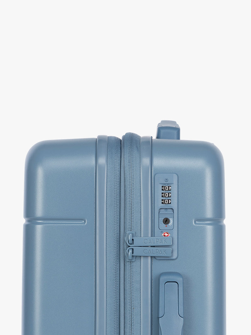 Side view and TSA approved lock of CALPAK Hue Carry On Luggage in light blue French Blue