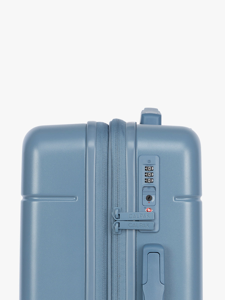 Side view with TSA lock of CALPAK Hue Medium Luggage in light blue French Blue and blue and white gingham interior ; LHU1024-FRENCH-BLUE