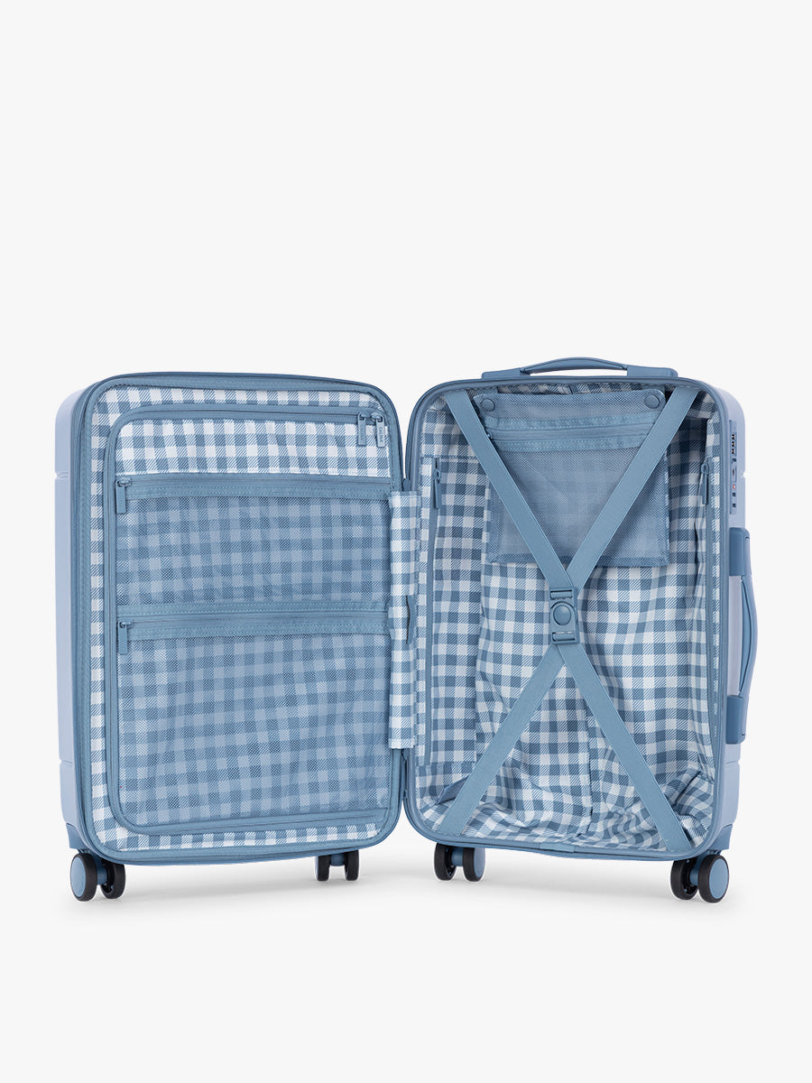 Opened view of CALPAK Hue Medium Luggage in light blue French Blue and blue and white gingham interior ; LHU1024-FRENCH-BLUE