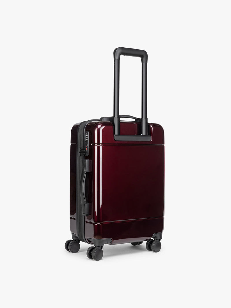 CALPAK Hue Carry On Luggage in Dark Cherry Red back view  on white background