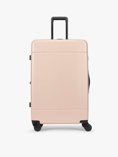 CALPAK Hue Large Luggage in light pink Rose Quartz with handle and wheels on a white background; LHU1028-ROSE-QUARTZ view 1