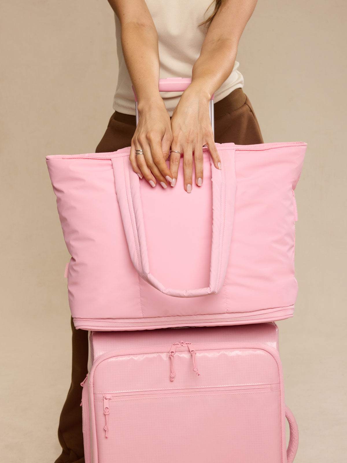 Model with CALPAK Luka Expandable Tote Bag in pink Blossom; ALT2201-BLOSSOM 
