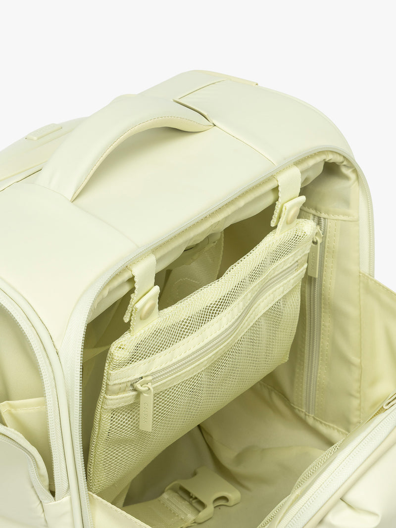 Interior mesh pocket of CALPAK Luka Soft-Sided Mini Carry On Luggage in light green Celadon with spinner wheels and handle