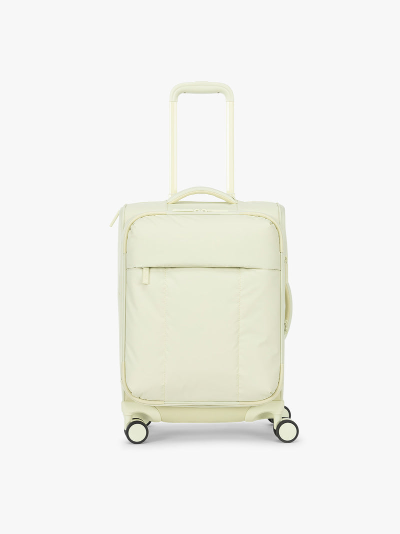 CALPAK Luka Soft-Sided Carry On Luggage in light green Celadon on a white background with handle and spinner wheels