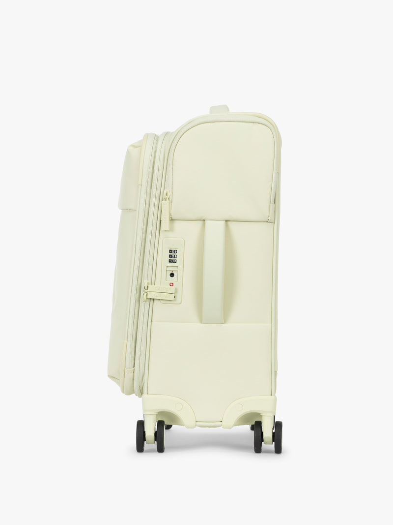 Side view and TSA approved lock of CALPAK Luka Soft-Sided Carry On Luggage in light green Celadon on a white background with handle and spinner wheels