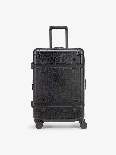 CALPAK TRNK medium 25 inch luggage with 360 spinner wheels and faux crocodile design in vintage trunk style in Black; LTK1024-BLACK-CROC view 1