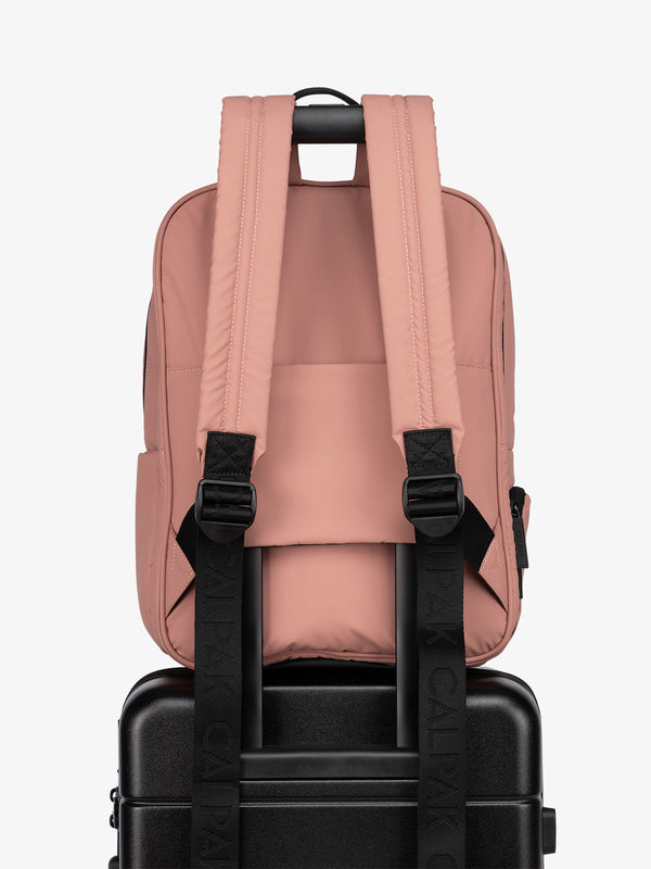 CALPAK water resistant Luka Laptop Backpack with adjustable shoulder straps and trolley sleeve in pink peony