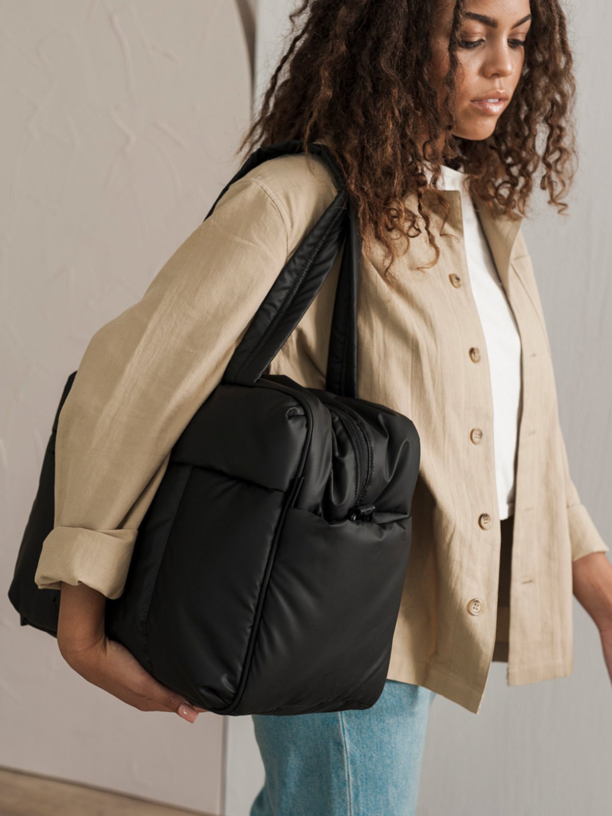 Model carrying Luka Duffel bag with dual handles in black