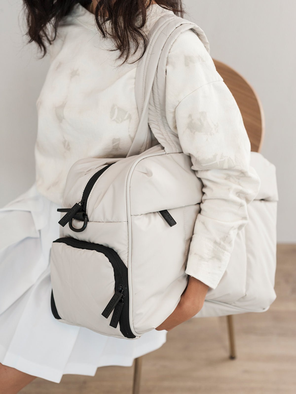 Model carrying Luka Duffel bag with dual handles in oatmeal