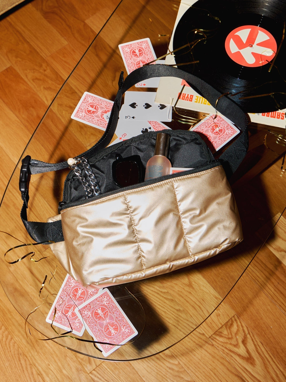 CALPAK Luka Belt Bag with items inside in gold; BB1901-GOLD