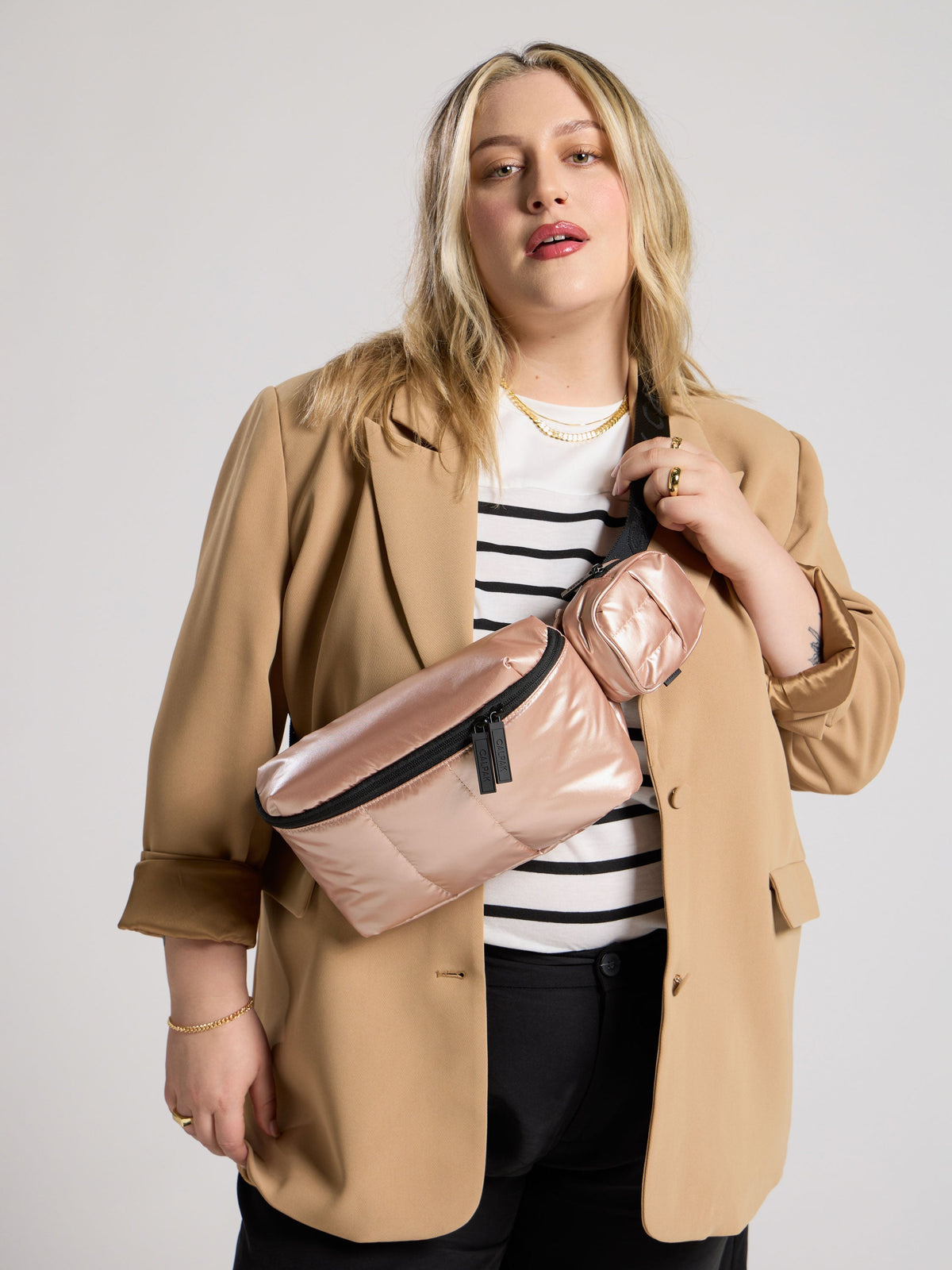 CALPAK Model wearings rose gold Luka Belt Bag as crossbody bag; BB1901-ROSE-GOLD