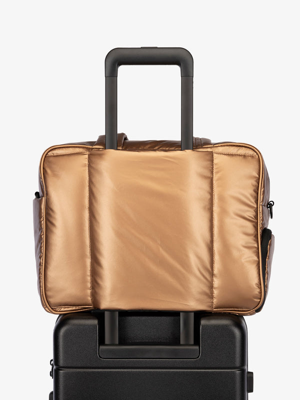 CALPAK Luka Duffel bag with luggage trolley sleeve in metallic copper