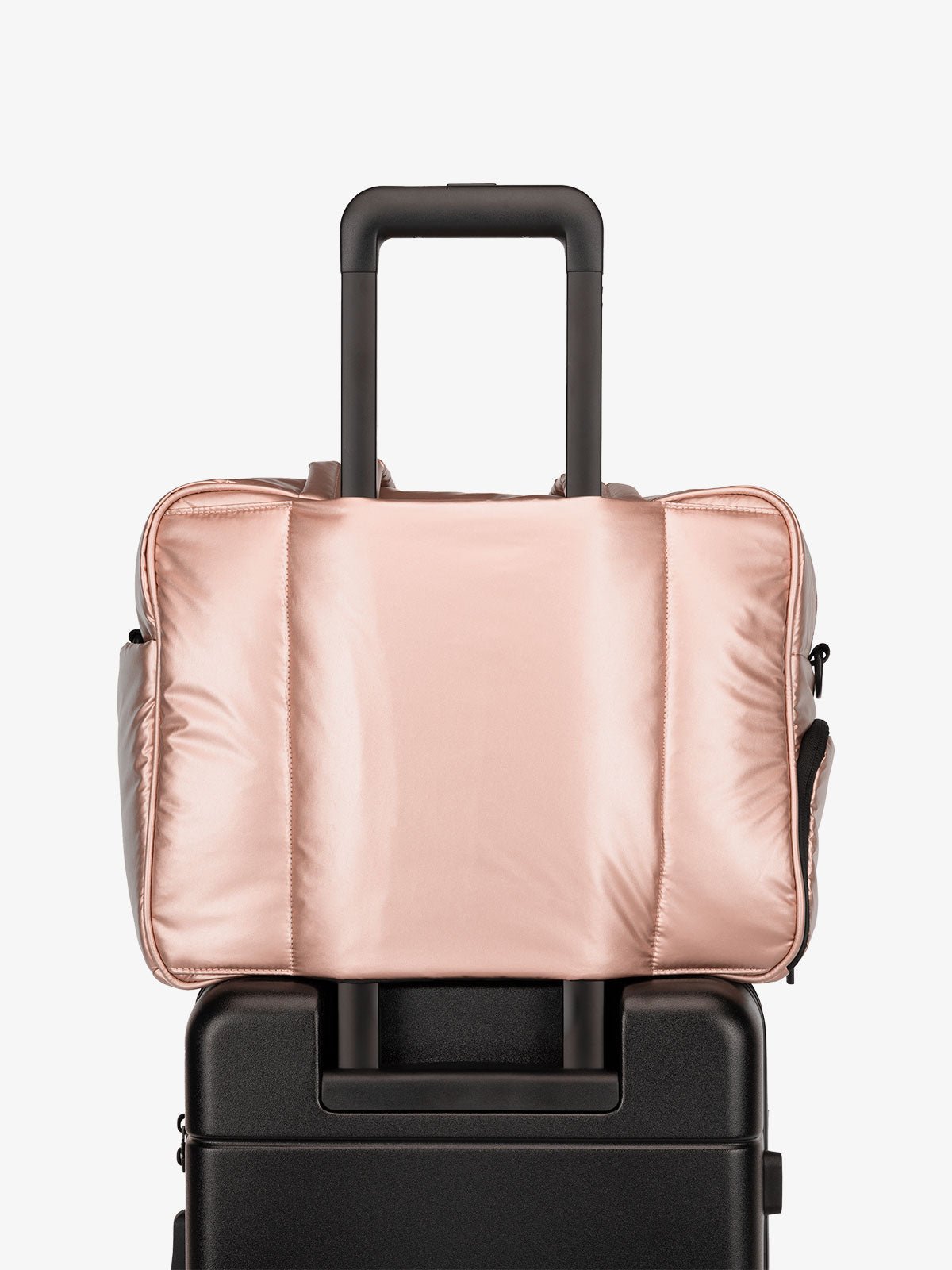 CALPAK Luka Duffel bag with luggage trolley sleeve in metallic pink rose gold