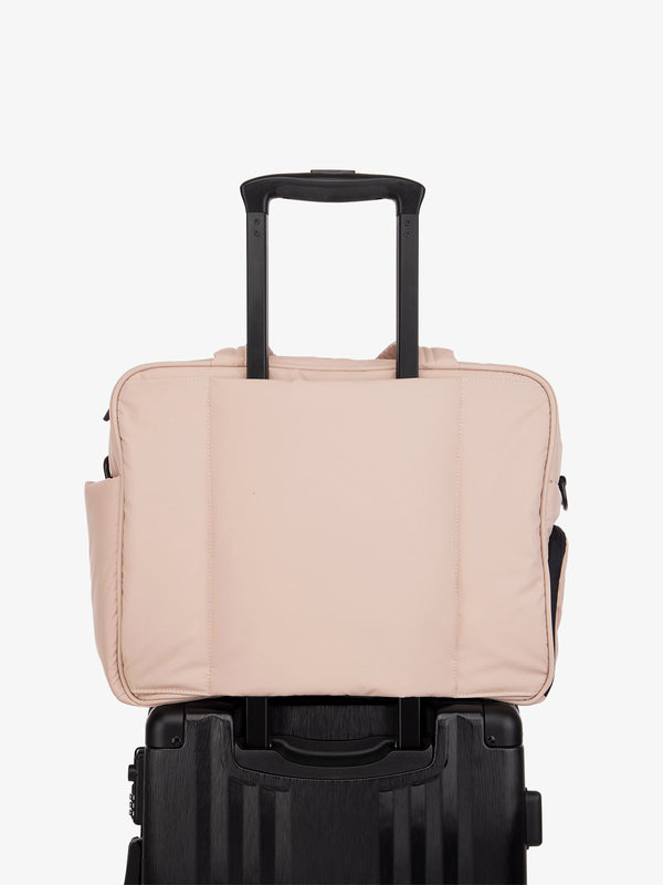 pink CALPAK Luka duffel bag with luggage trolley sleeve
