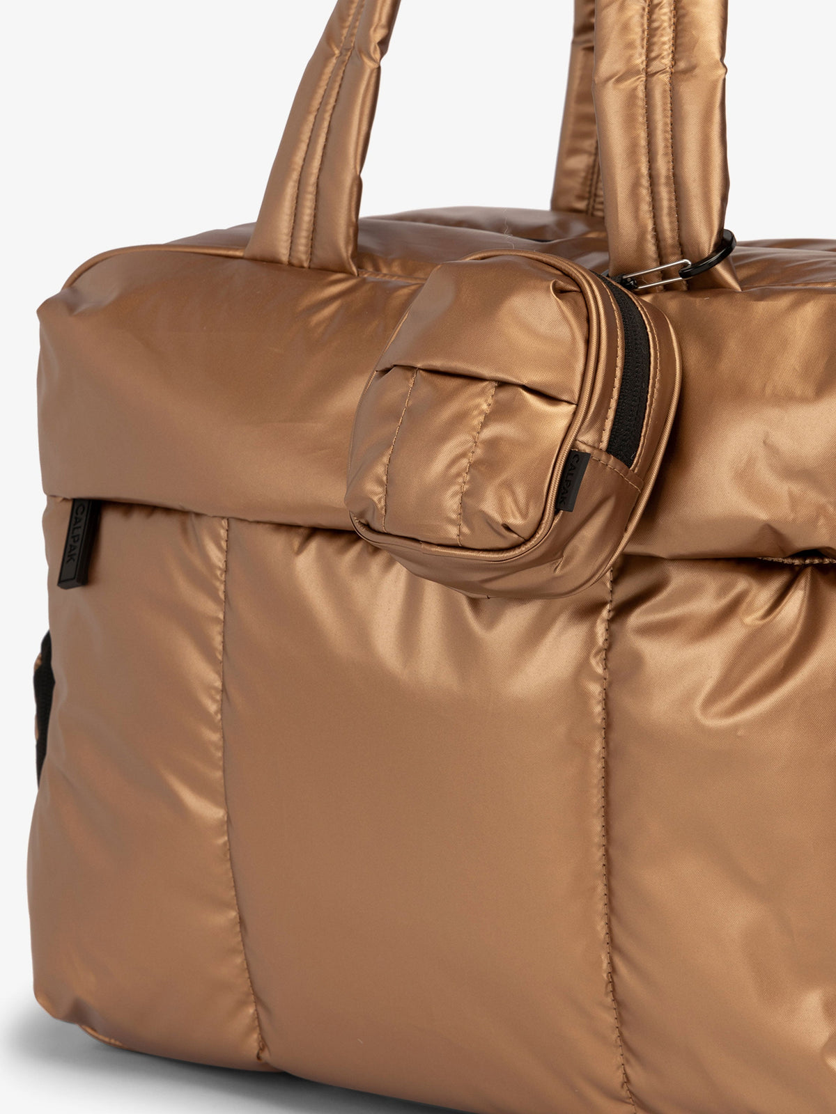 CALPAK Luka mini backpack keychain attached to duffel with carabiner clip in metallic copper; AMB2201-COPPER